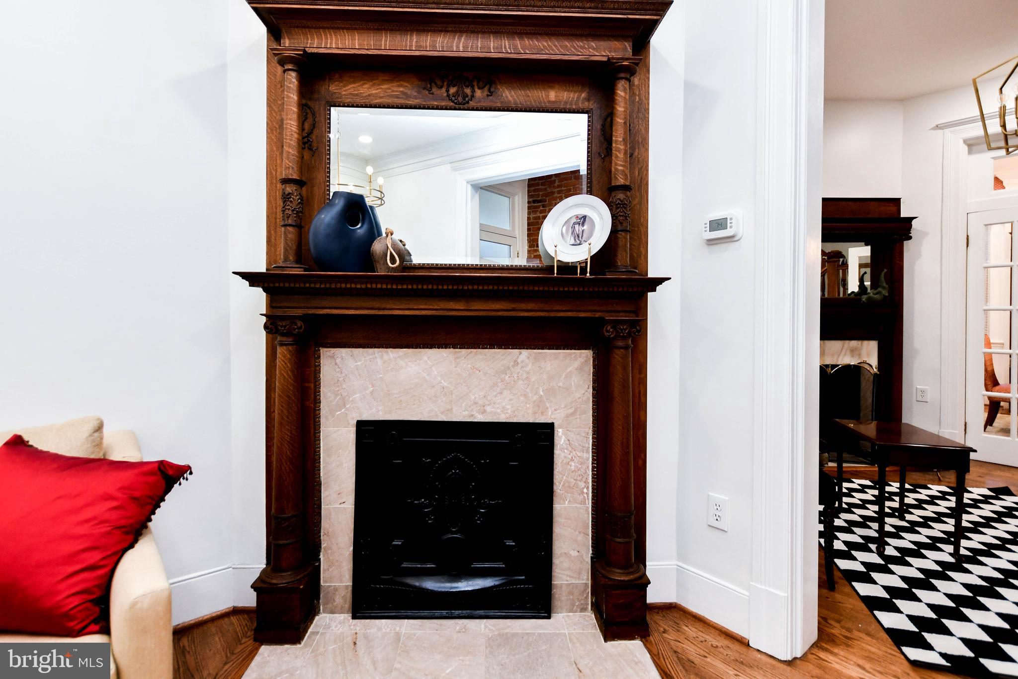 34 R Street Northeast Washington, DC 20002 - Photo 9 of 74 a living room with a fireplace and a mirror