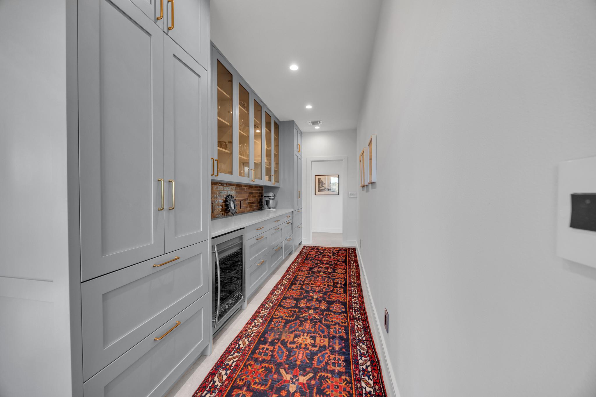 24710 Fossil Trail Spicewood, TX 78669 - Photo 12 of 40 a kitchen with white cabinets and white appliances