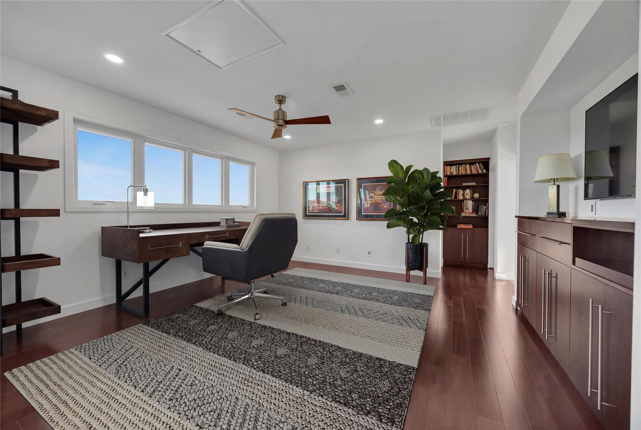 24710 Fossil Trail Spicewood, TX 78669 - Photo 18 of 40 a living room with furniture and a wooden floor