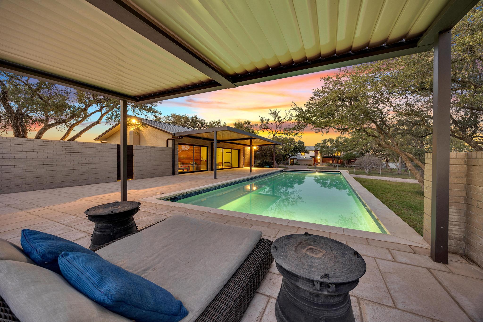 24710 Fossil Trail Spicewood, TX 78669 - Photo 26 of 40 a backyard of a house with table and chairs