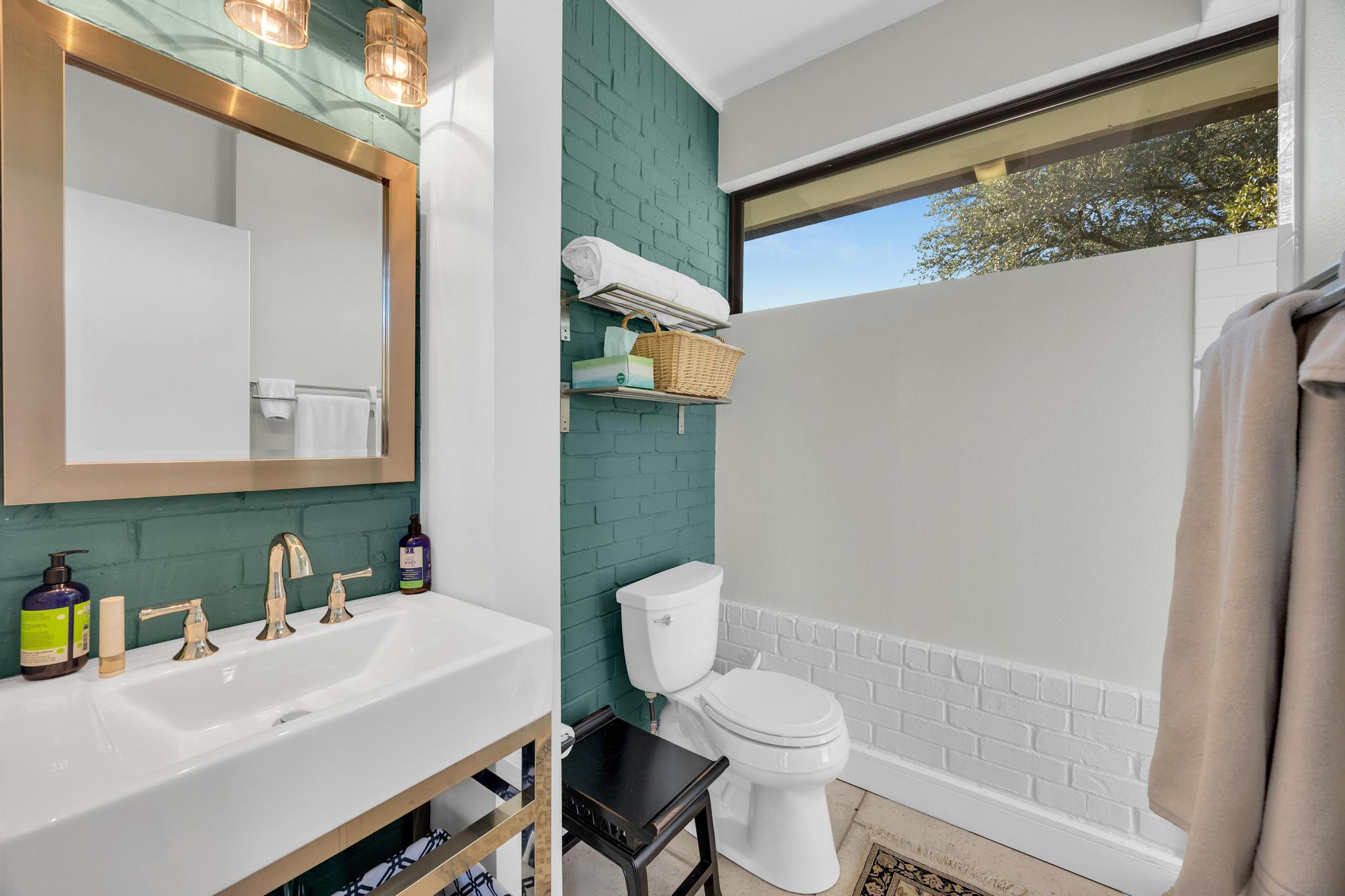 24710 Fossil Trail Spicewood, TX 78669 - Photo 30 of 40 a bathroom with a sink a toilet and a mirror