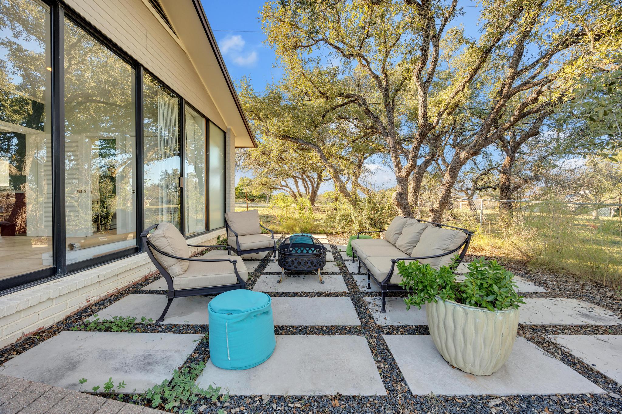 24710 Fossil Trail Spicewood, TX 78669 - Photo 32 of 40 a view of a backyard with sitting area