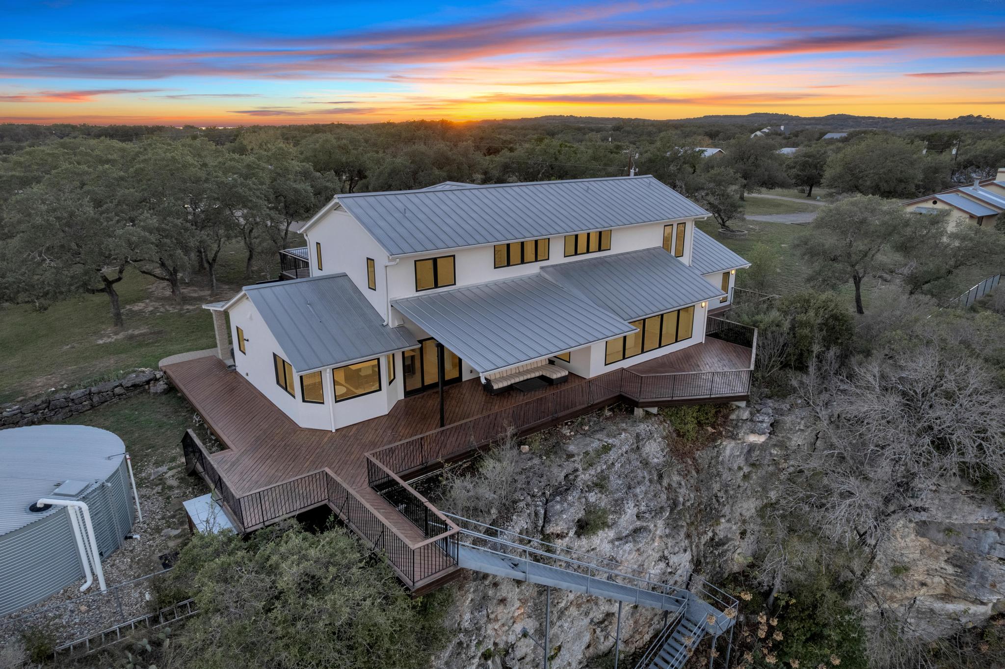 24710 Fossil Trail Spicewood, TX 78669 - Photo 33 of 40 an aerial view of residential houses with outdoor space and ocean view