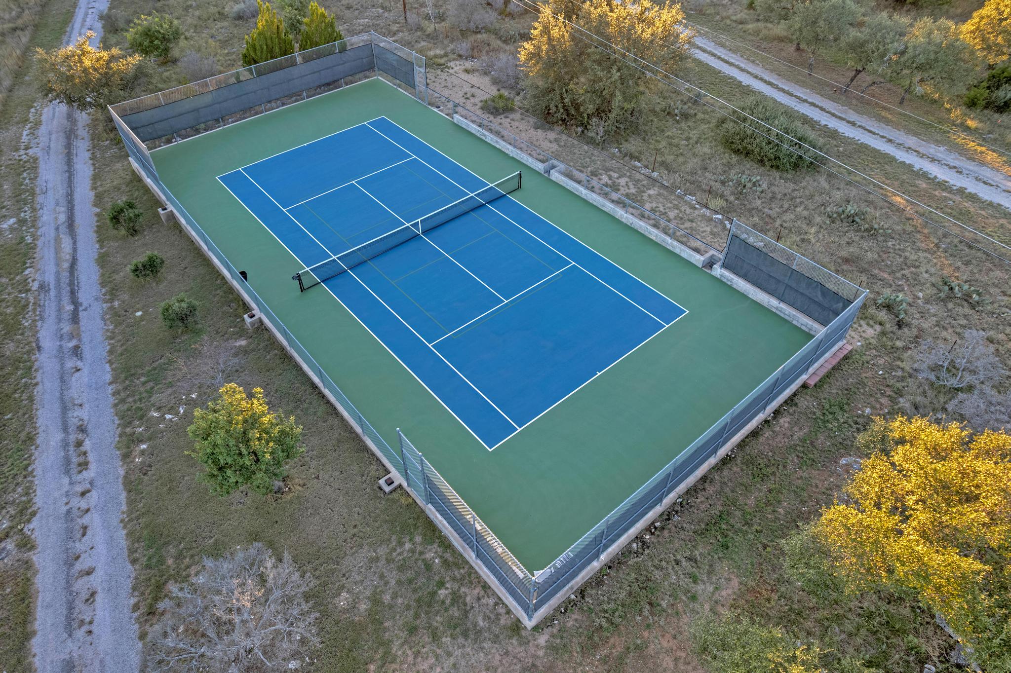 24710 Fossil Trail Spicewood, TX 78669 - Photo 37 of 40 a view of a tennis court