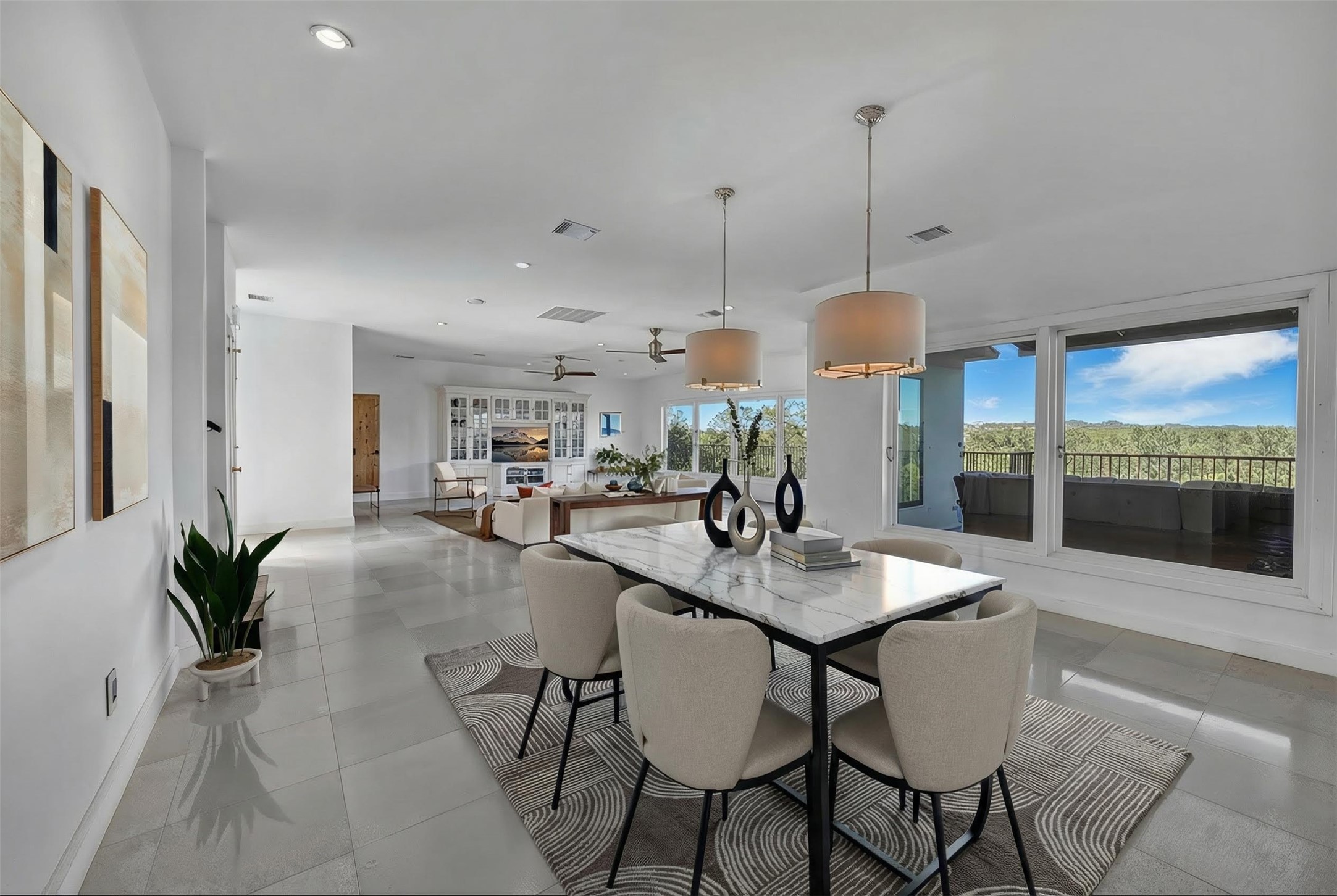 24710 Fossil Trail Spicewood, TX 78669 - Photo 8 of 40 a dining room with furniture and a chandelier