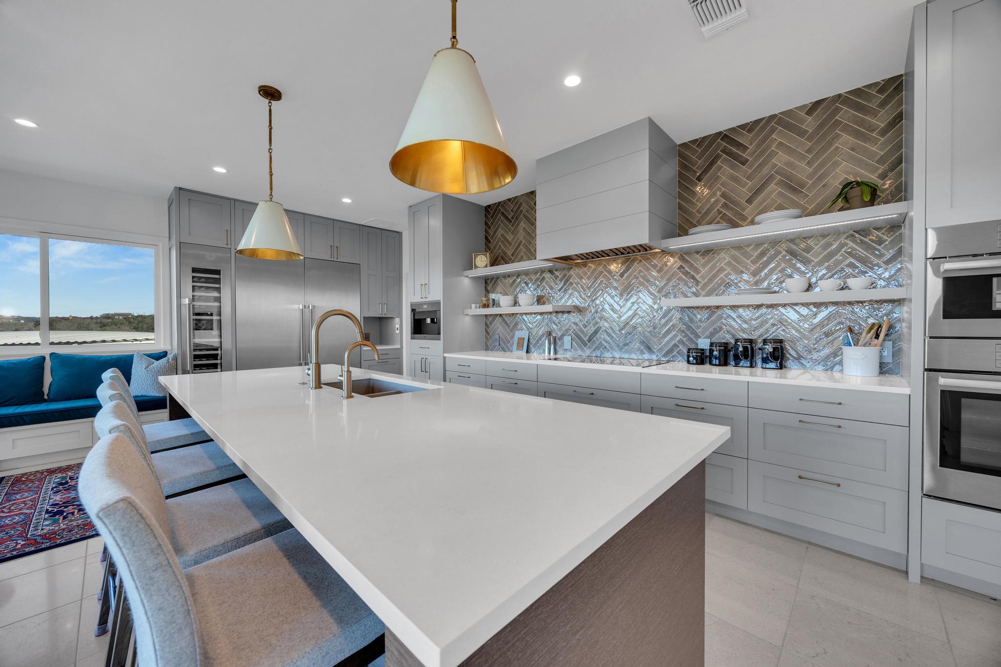 24710 Fossil Trail Spicewood, TX 78669 - Photo 9 of 40 a large kitchen with a table and chairs in it