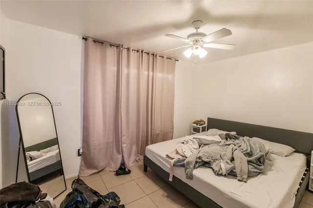 a bedroom with a bed and a mirror