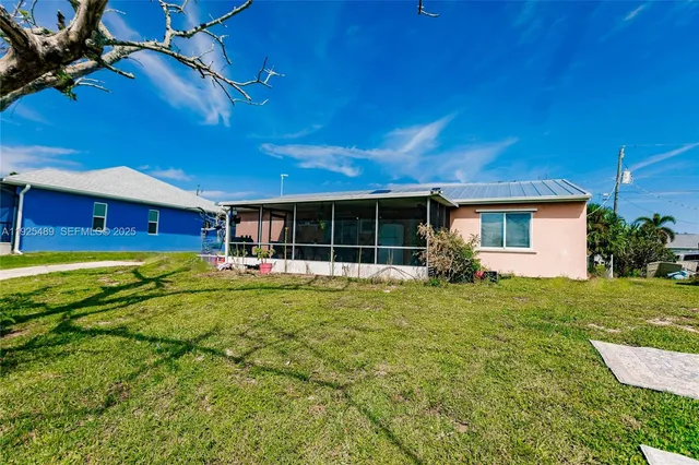 a view of a house with backyard and porch