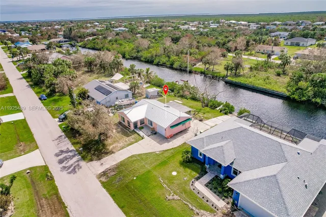 an aerial view of residential houses with outdoor space