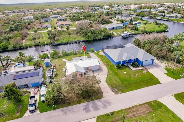 an aerial view of a house with yard swimming pool and outdoor seating