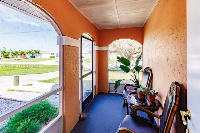 a view of a porch with furniture and a potted plant