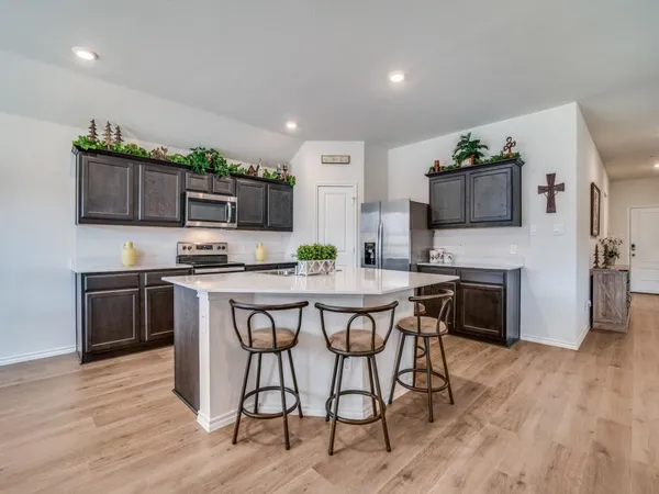 a kitchen with stainless steel appliances a sink a stove and cabinets