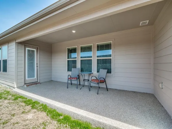 a living room with furniture wooden floor and a view of kitchen