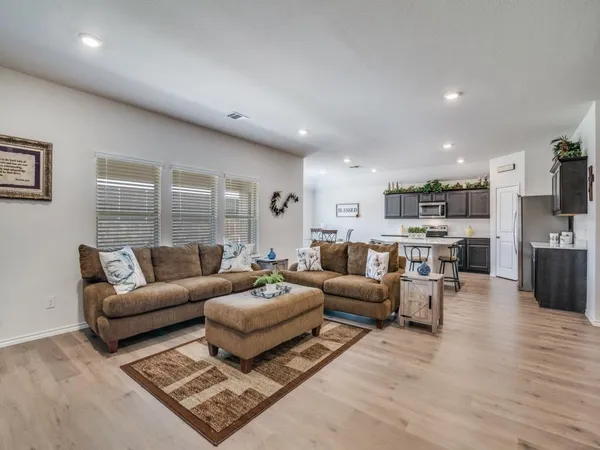 a living room with furniture wooden floor and a flat screen tv
