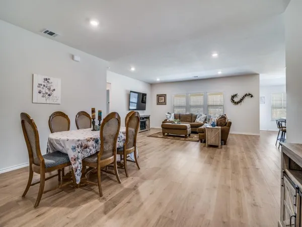 a view of a dining room with furniture and wooden floor
