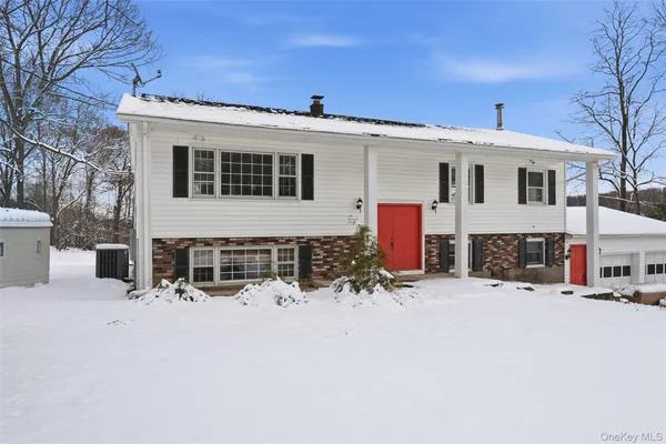 a view of a house with snow on the road