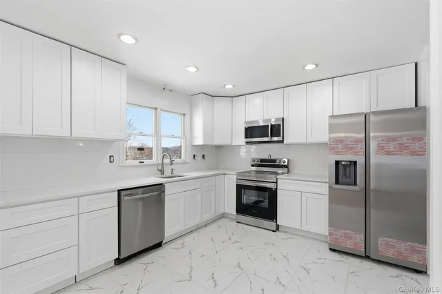 a kitchen with stainless steel appliances granite countertop a refrigerator sink and cabinets