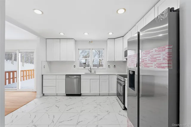 a view of a hallway with washer and dryer