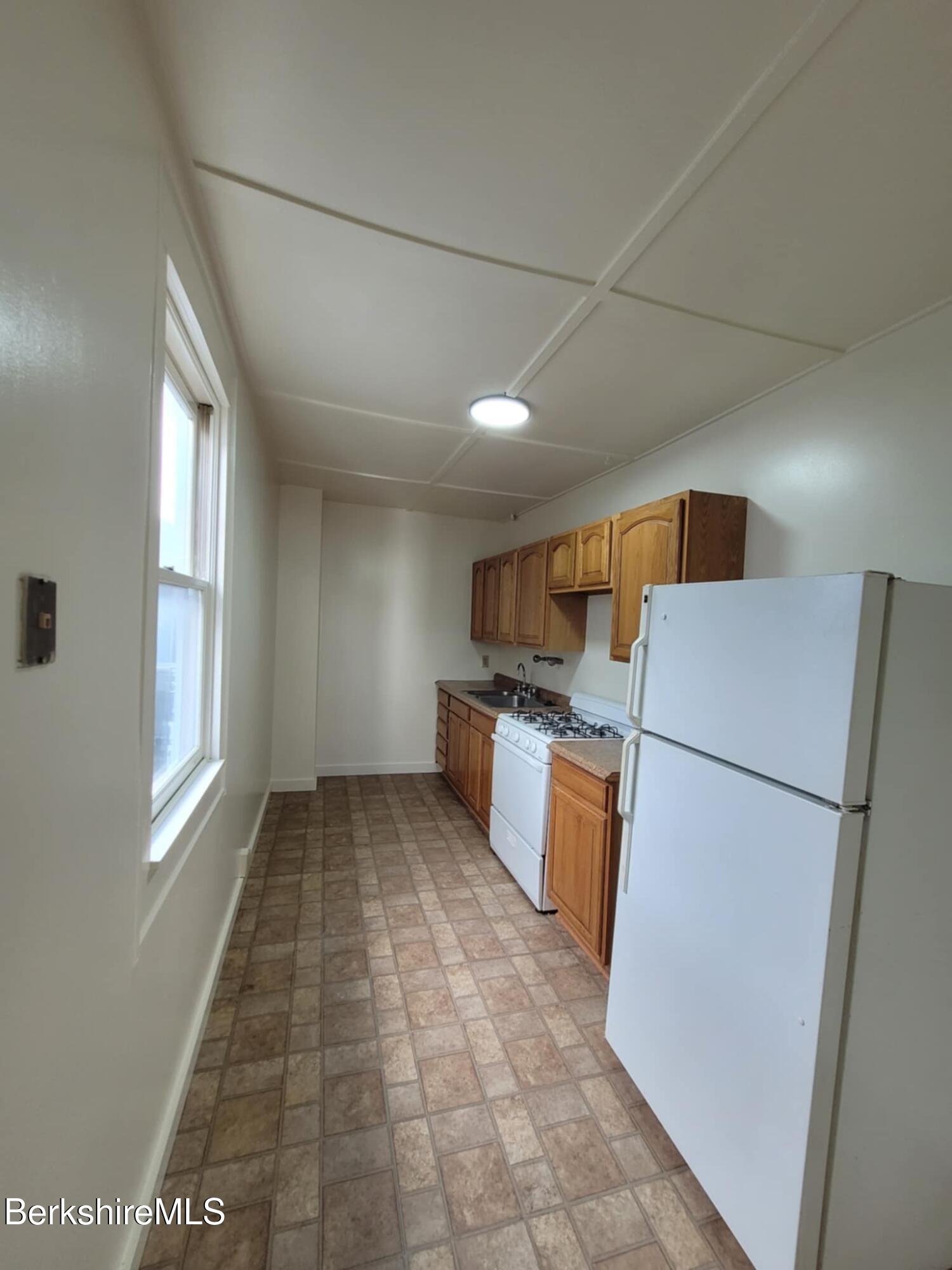 35 Pleasant Street Adams, MA 01220 - Photo 3 of 7 a kitchen with refrigerator a microwave and sink