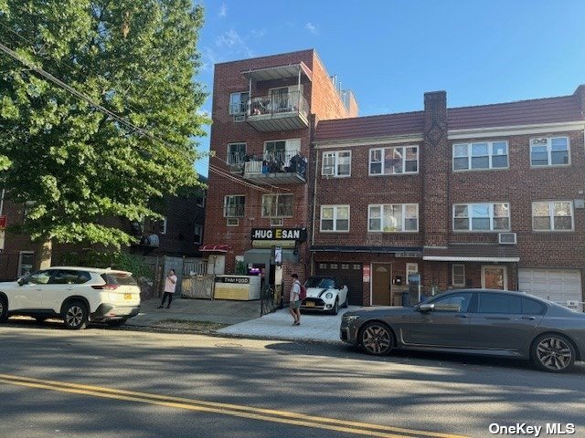 77-16 Woodside Avenue, Unit R1 Queens, NY 11373 - Photo 2 of 4 a view of a building with car parked