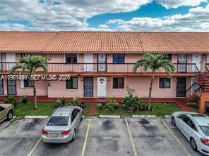 2154 West 60th Street, Unit 12218 Hialeah, FL 33016 - Photo 1 of 2 a front view of a house with a garden and plants