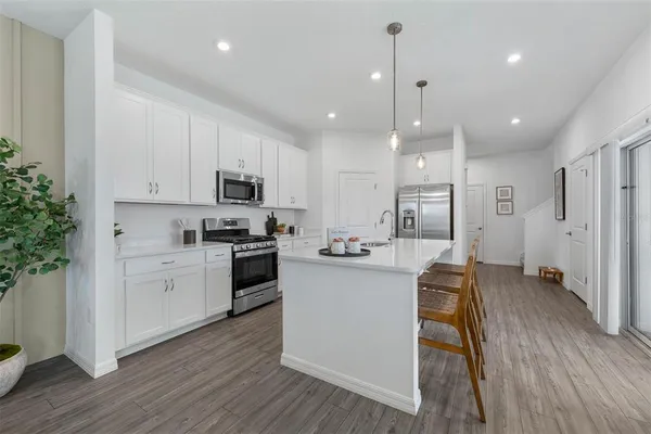 a kitchen with stainless steel appliances granite countertop a stove oven and a refrigerator