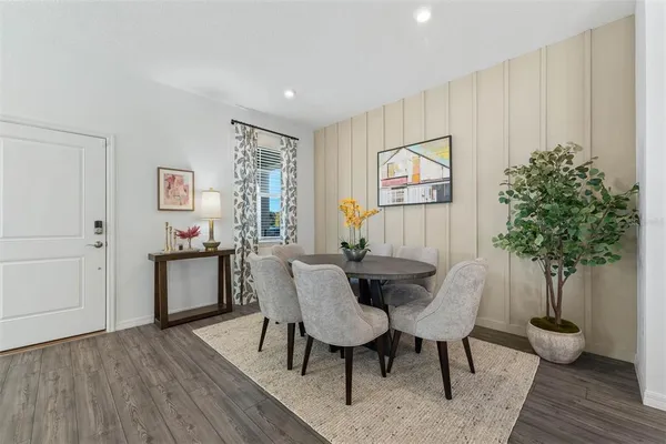a view of a dining room with furniture and wooden floor