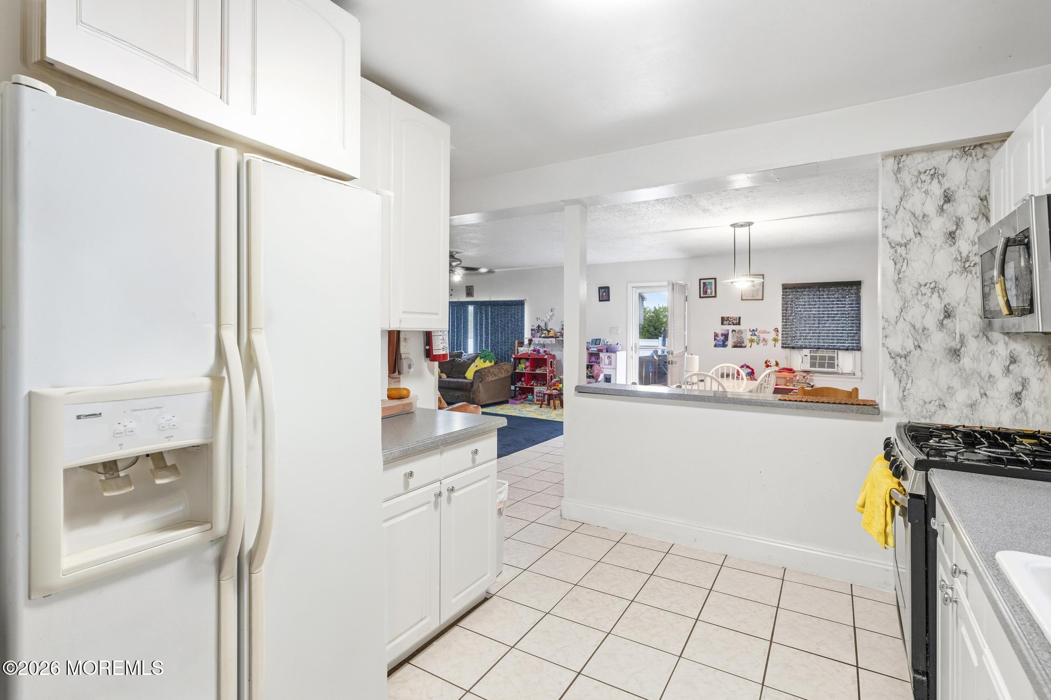 1914 Rutherford Avenue Neptune Township, NJ 07753 - Photo 4 of 25 a kitchen with cabinets and appliances