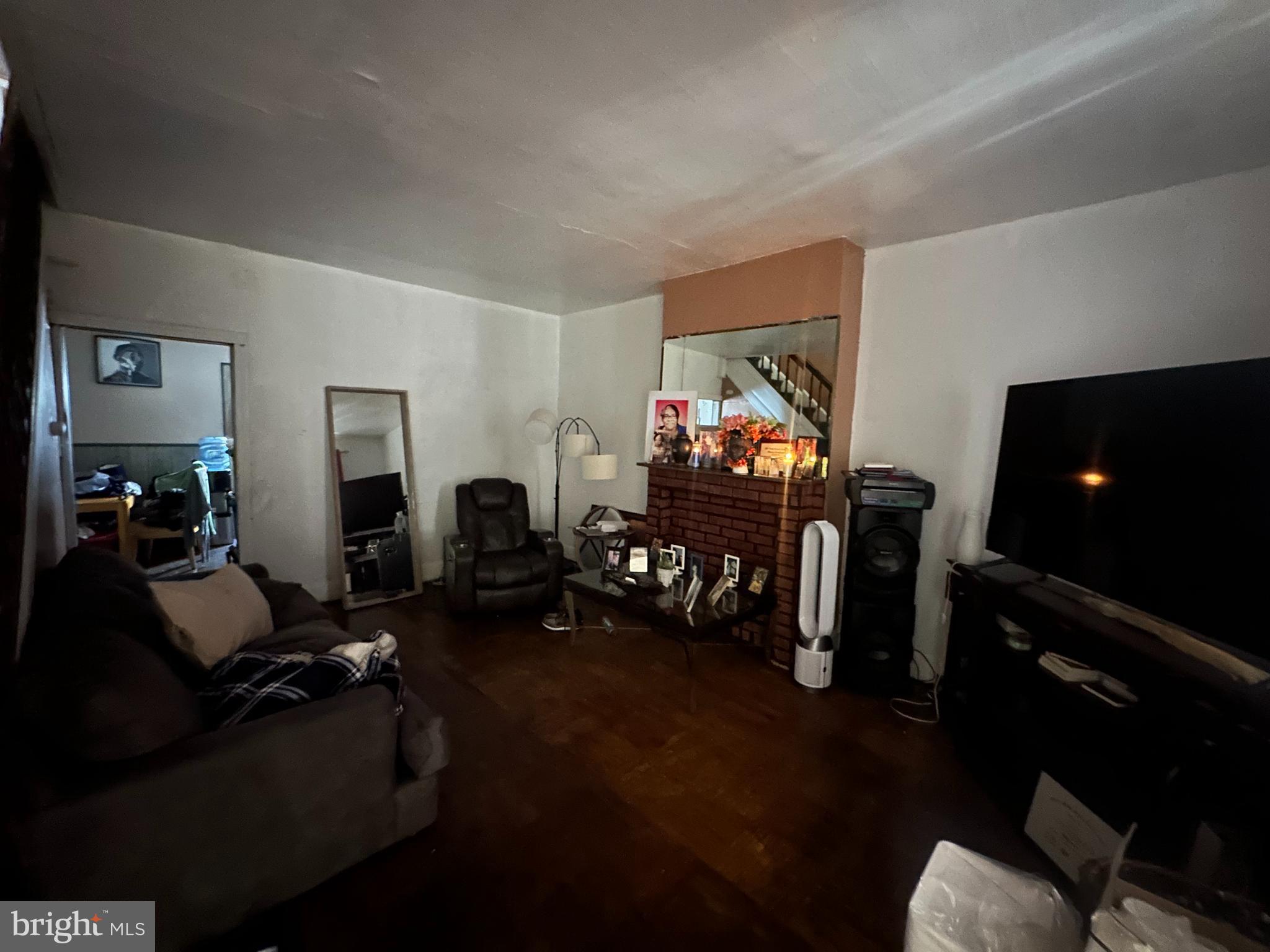 5024 Duffield Street Philadelphia, PA 19124 - Photo 3 of 18 a living room with furniture a flat screen tv and gym equipment
