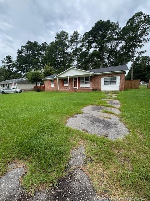 Undisclosed Address Raeford, NC 28376 - Photo 1 of 12 a front view of a house with a garden