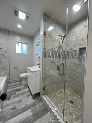 a bathroom with a shower toilet and sink