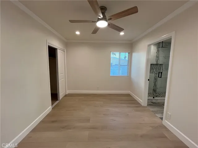 an empty room with closet and windows