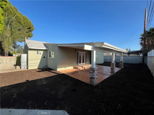 a view of a house with backyard and sitting area