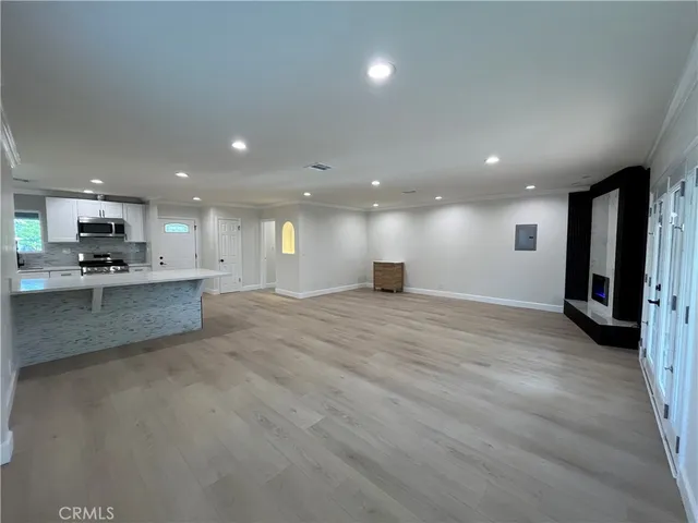 a view of kitchen with kitchen island and stainless steel appliances