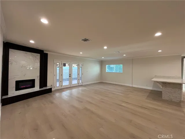 an empty room with a fireplace and windows
