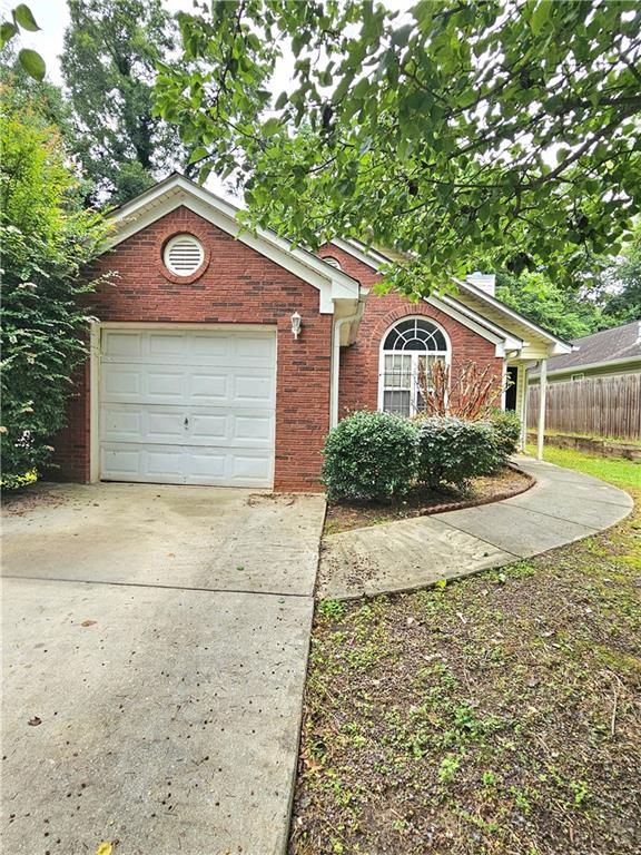 2285 Butner Road Atlanta, GA 30331 - Photo 1 of 1 a front view of a house with a yard and garage