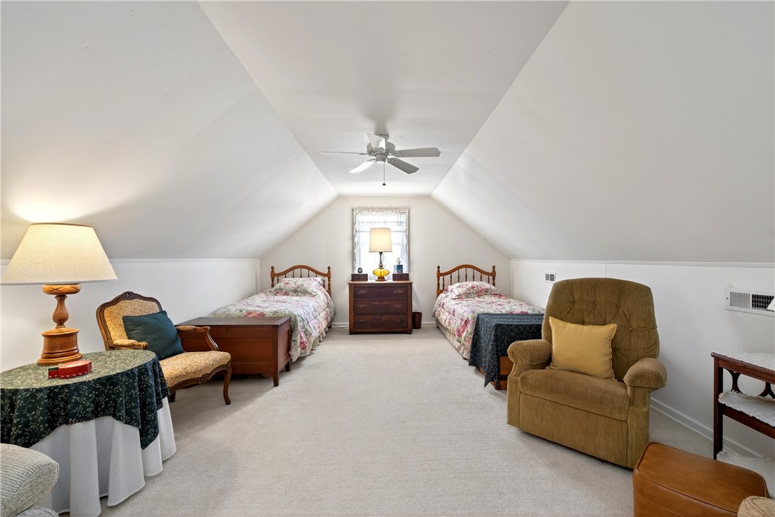 1237 Laurelwood Road Dayton, OH 45409 - Photo 31 of 56 This cozy bedroom features sloped ceilings and soft carpeting, creating a comfortable and inviting atmosphere.
