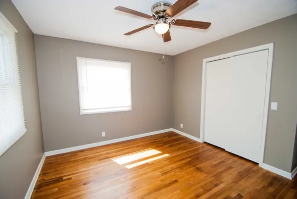 a view of a room with wooden floor and a window