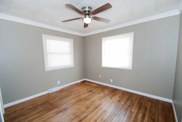wooden floor in an empty room with a window