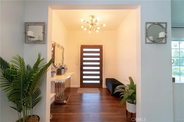 a hallway with a flower pot and a bookshelf