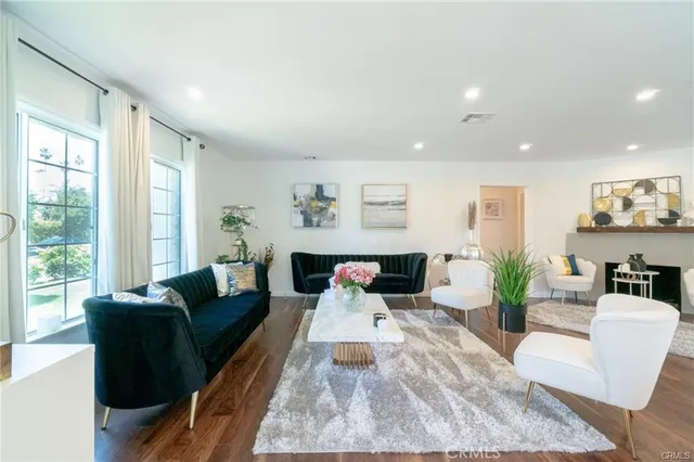 a living room with furniture and wooden floor