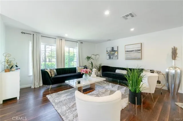 a living room with furniture and a potted plant