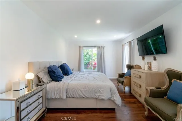 a bedroom with a bed and a flat screen tv