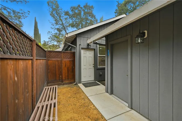 a view of a house with wooden fence
