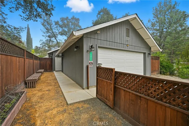 a view of a house with a wooden fence