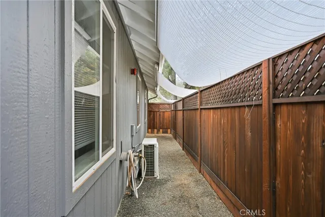 a backyard of a house with potted plants and outdoor seating