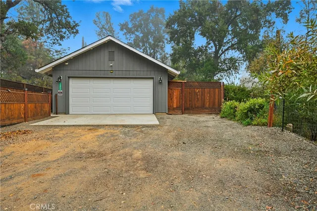 an aerial view of residential house with outdoor space and trees all around