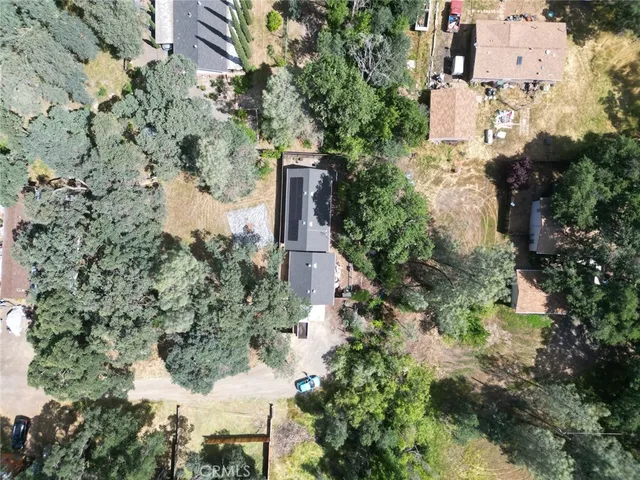 an aerial view of a house with a yard