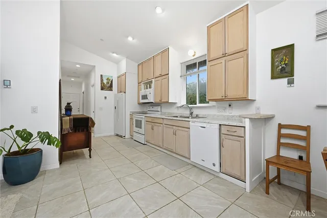 a kitchen with a stove a sink and a refrigerator