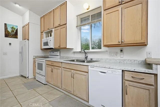a kitchen with stainless steel appliances granite countertop a sink and a cabinets